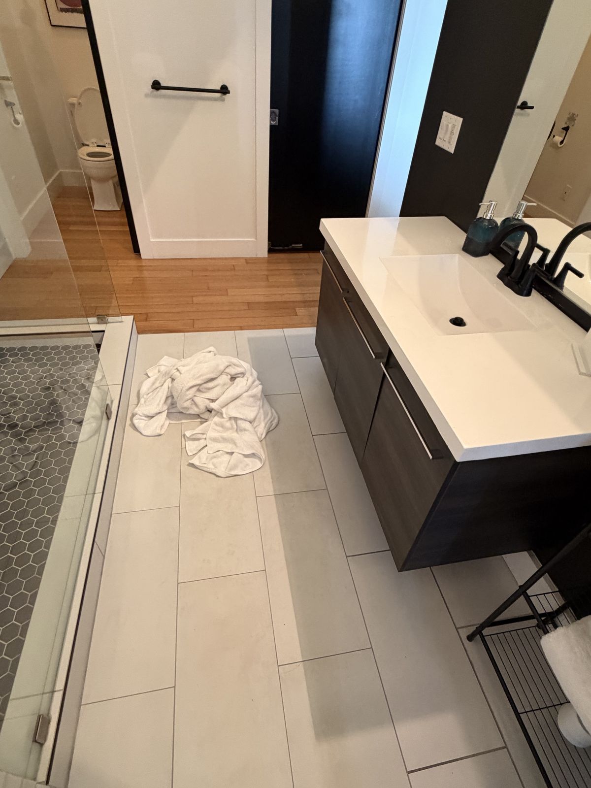 Used towels and an empty shower after the guests leave