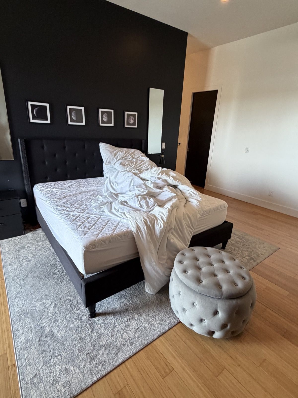 Checkout morning in the master suite: bed stripped, duvet piled on the mattress
