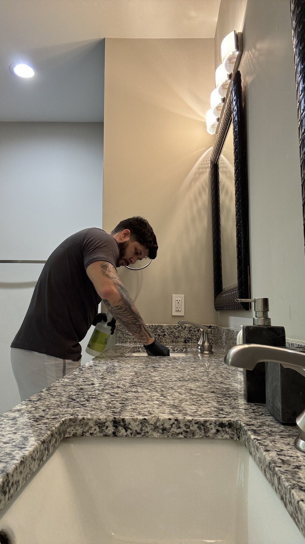 Klinner cleaner detailing an Airbnb bathroom vanity