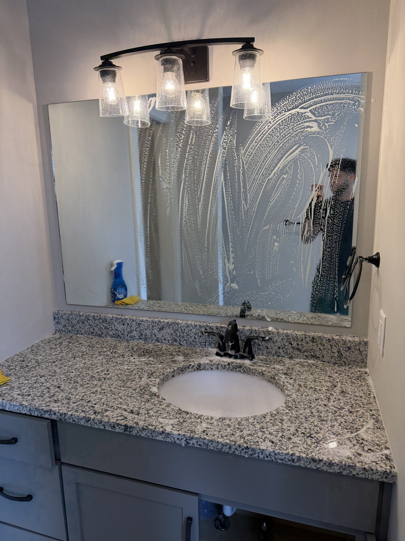 Bathroom mirror with cleaning foam during deep cleaning